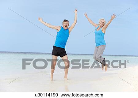 Senior Couple Jumping On Beautiful Beach View Large Photo Image Stock Image - Senior Couple Jumping On Beautiful Beach. Fotosearch