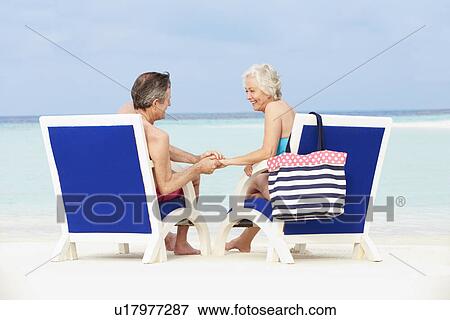 Senior Couple On Beach Relaxing In Chairs View Large Photo Image Stock Photo - Senior Couple On Beach Relaxing In Chairs. Fotosearch