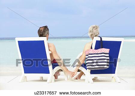 Senior Couple On Beach Relaxing In Chairs View Large Photo Image Stock Photo - Senior Couple On Beach Relaxing In Chairs. Fotosearch
