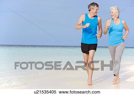 Senior Couple Running On Beautiful Beach View Large Photo Image Stock Photography - Senior Couple Running On Beautiful Beach. Fotosearch