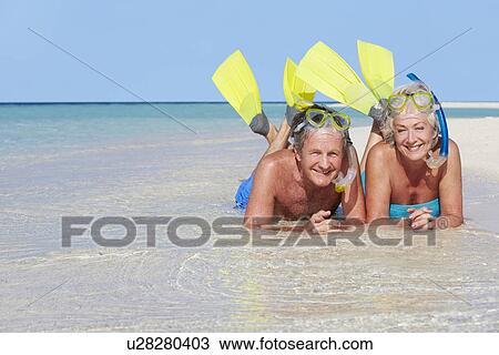 Senior Couple With Snorkels Enjoying Beach Holiday View Large Photo Image Stock Image - Senior Couple With Snorkels Enjoying Beach Holiday. Fotosearch
