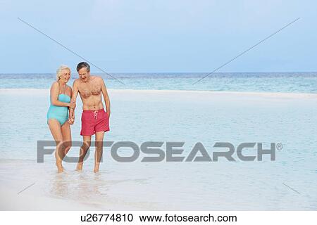 Senior Romantic Couple Walking In Beautiful Tropical Sea View Large Photo Image Stock Image - Senior Romantic Couple Walking In Beautiful Tropical Sea. Fotosearch