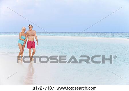 Senior Romantic Couple Walking In Beautiful Tropical Sea View Large Photo Image Stock Photo - Senior Romantic Couple Walking In Beautiful Tropical Sea. Fotosearch