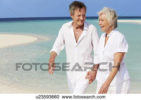 Senior Romantic Couple Walking On Beautiful Tropical Beach View Large Photo Image Stock Image - Senior Romantic Couple Walking On Beautiful Tropical Beach. Fotosearch