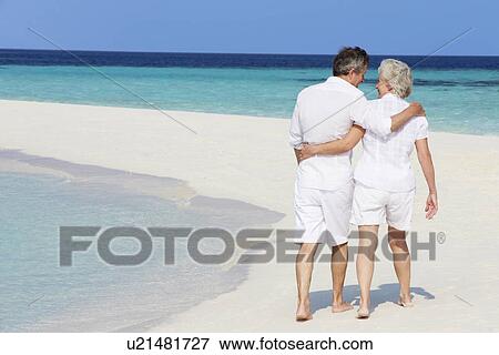Senior Romantic Couple Walking On Beautiful Tropical Beach View Large Photo Image Stock Photo - Senior Romantic Couple Walking On Beautiful Tropical Beach. Fotosearch