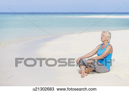 Senior Woman Meditating On Beautiful Beach View Large Photo Image Stock Image - Senior Woman Meditating On Beautiful Beach. Fotosearch