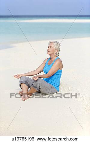 Senior Woman Meditating On Beautiful Beach View Large Photo Image Stock Photograph - Senior Woman Meditating On Beautiful Beach. Fotosearch