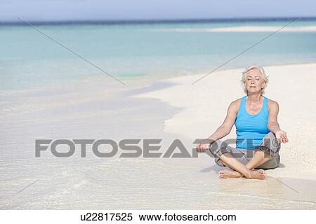 Senior Woman Meditating On Beautiful Beach View Large Photo Image Stock Photography - Senior Woman Meditating On Beautiful Beach. Fotosearch
