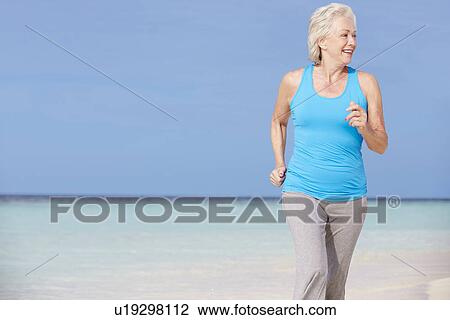 Senior Woman Running On Beautiful Beach View Large Photo Image Stock Image - Senior Woman Running On Beautiful Beach. Fotosearch