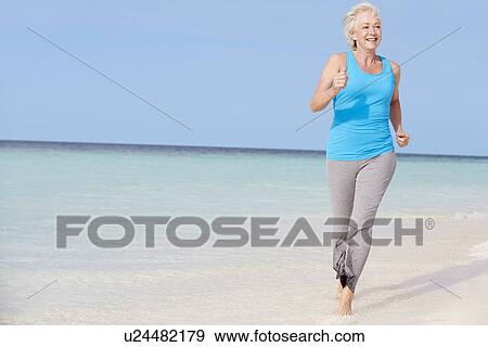 Senior Woman Running On Beautiful Beach View Large Photo Image Stock Photo - Senior Woman Running On Beautiful Beach. Fotosearch