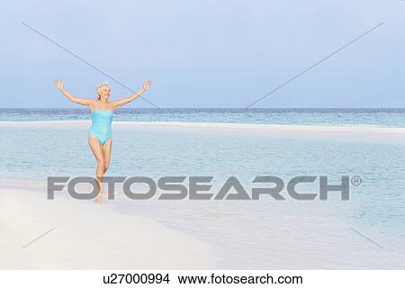 Senior Woman Splashing In Beautiful Tropical Sea View Large Photo Image Picture - Senior Woman Splashing In Beautiful Tropical Sea. Fotosearch