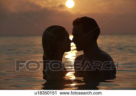 Silhouette Of Romantic Couple Standing In Sea View Large Photo Image Stock Image - Silhouette Of Romantic Couple Standing In Sea. Fotosearch