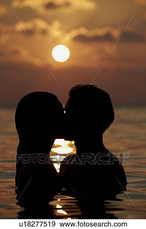 Silhouette Of Romantic Couple Standing In Sea View Large Photo Image Stock Photo - Silhouette Of Romantic Couple Standing In Sea. Fotosearch