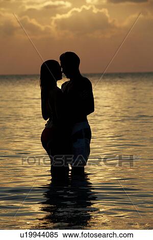 Stock Photography - Silhouette Of Romantic Couple Standing In Sea. Fotosearch