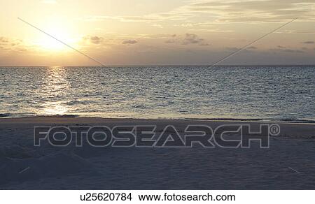 Sun Setting Over Beautiful Deserted Beach View Large Photo Image Picture - Sun Setting Over Beautiful Deserted Beach. Fotosearch