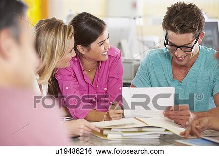 Stock Photograph - Team Meeting In Creative Office. Fotosearch