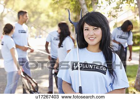 Stock Image - Team Of Volunteers Picking Up Litter In Suburban Street. Fotosearch