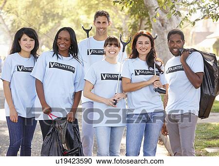 Stock Image - Team Of Volunteers Picking Up Litter In Suburban Street. Fotosearch