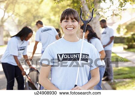 Stock Image - Team Of Volunteers Picking Up Litter In Suburban Street. Fotosearch