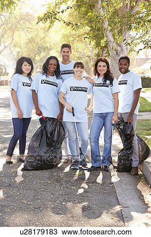 Stock Image - Team Of Volunteers Picking Up Litter In Suburban Street. Fotosearch