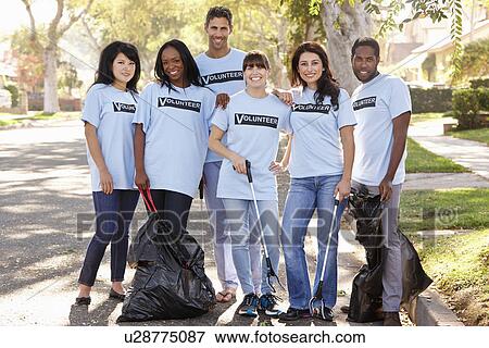 Stock Photo - Team Of Volunteers Picking Up Litter In Suburban Street. Fotosearch