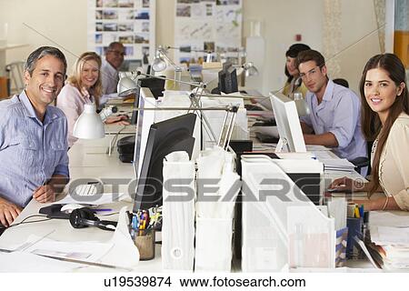 Picture - Team Working At Desks In Busy Office. Fotosearch