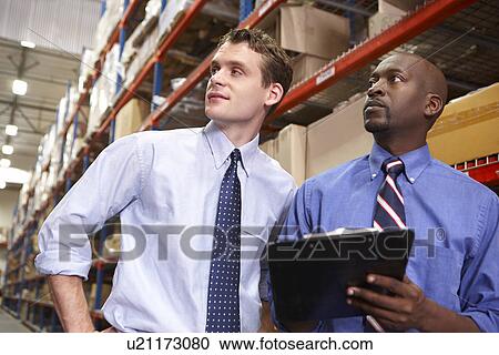 Two Businessmen With Clipboard In Warehouse View Large Photo Image Stock Image - Two Businessmen With Clipboard In Warehouse. Fotosearch