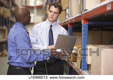 Two Businessmen With Laptop In Warehouse View Large Photo Image Stock Image - Two Businessmen With Laptop In Warehouse. Fotosearch