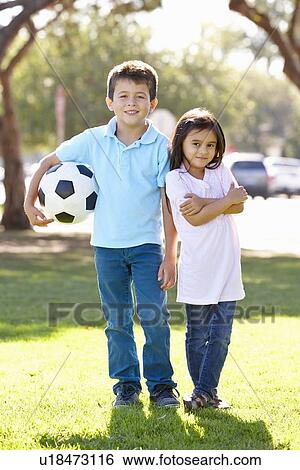 Stock Photograph - Two Children Playing Soccer Together. Fotosearch