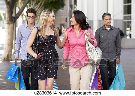 Two Couples With Bored Men Carrying Partners Bags View Large Photo Image Picture - Two Couples With Bored Men Carrying Partners Bags. Fotosearch
