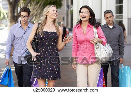 Two Couples With Bored Men Carrying Partners Bags View Large Photo Image Stock Photo - Two Couples With Bored Men Carrying Partners Bags. Fotosearch