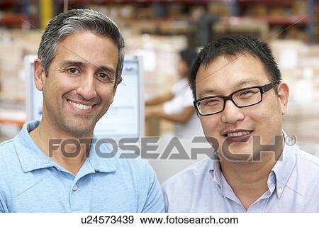 Two Men At Computer Terminal In Distribution Warehouse View Large Photo Image Stock Photo - Two Men At Computer Terminal In Distribution Warehouse. Fotosearch