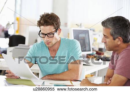 Stock Photography - Two Men Meeting In Creative Office. Fotosearch