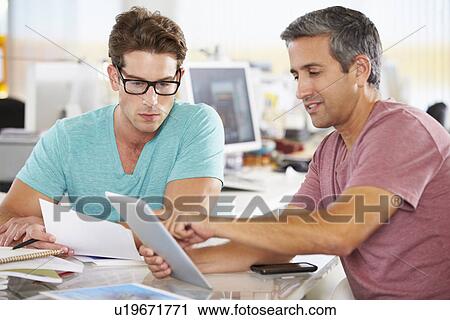 Two Men Using Tablet Computer In Creative Office View Large Photo Image Stock Image - Two Men Using Tablet Computer In Creative Office. Fotosearch