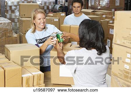 Volunteers Collecting Food Donations In Warehouse View Large Photo Image Stock Photo - Volunteers Collecting Food Donations In Warehouse. Fotosearch