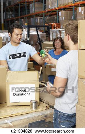 Volunteers Collecting Food Donations In Warehouse View Large Photo Image Stock Photo - Volunteers Collecting Food Donations In Warehouse. Fotosearch