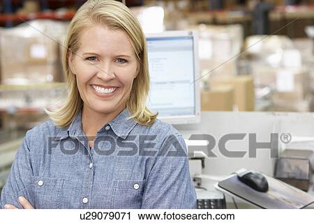Woman At Computer Terminal In Distribution Warehouse View Large Photo Image Stock Image - Woman At Computer Terminal In Distribution Warehouse. Fotosearch