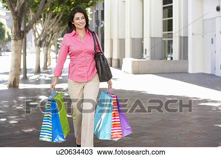 Woman Carrying Shopping Bags On City Street View Large Photo Image Stock Image - Woman Carrying Shopping Bags On City Street. Fotosearch