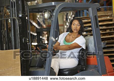 Woman Driving Fork Lift Truck In Warehouse View Large Photo Image Stock Photo - Woman Driving Fork Lift Truck In Warehouse. Fotosearch