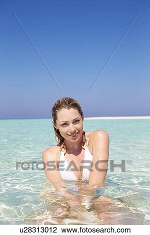 Stock Image - Woman Enjoying Beach Holiday. Fotosearch