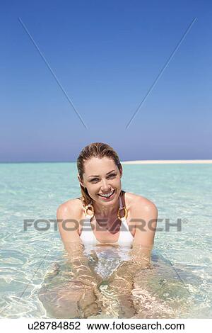 Stock Image - Woman Enjoying Beach Holiday. Fotosearch