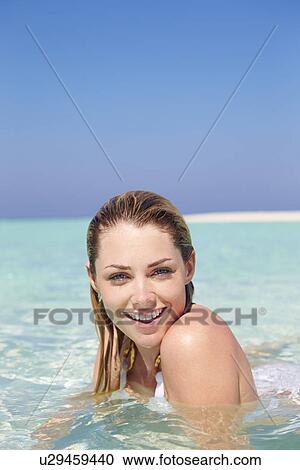 Stock Image - Woman Enjoying Beach Holiday. Fotosearch