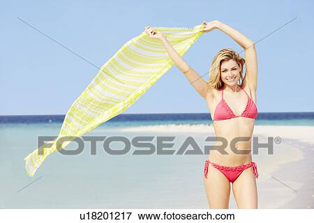 Woman In Bikini On Beautiful Tropical Beach Holding Sarong View Large Photo Image Stock Photo - Woman In Bikini On Beautiful Tropical Beach Holding Sarong. Fotosearch