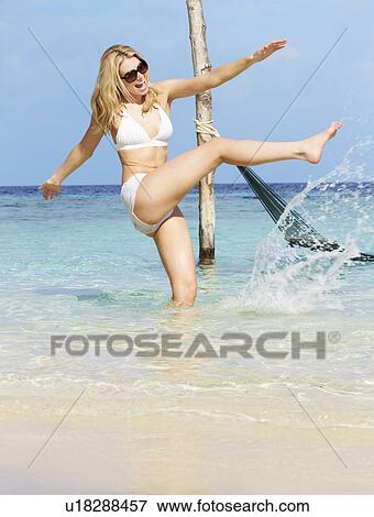 Stock Photo - Woman In Bikini Splashing In Beautiful Tropical Sea. Fotosearch