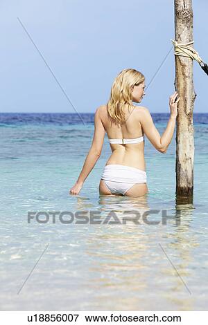 Woman In Bikini Standing In Beautiful Tropical Sea View Large Photo Image Stock Photo - Woman In Bikini Standing In Beautiful Tropical Sea. Fotosearch