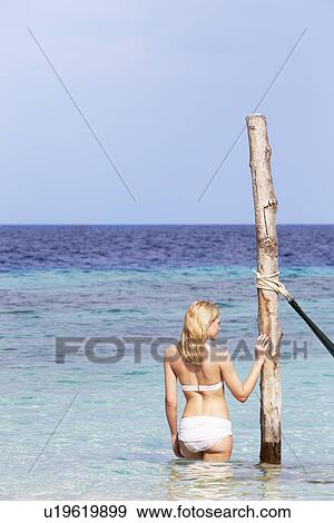 Woman In Bikini Standing In Beautiful Tropical Sea View Large Photo Image Stock Photo - Woman In Bikini Standing In Beautiful Tropical Sea. Fotosearch