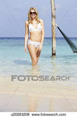 Stock Photo - Woman In Bikini Standing In Beautiful Tropical Sea. Fotosearch