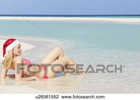 Woman Lying On Beach Wearing Santa Hat View Large Photo Image Stock Image - Woman Lying On Beach Wearing Santa Hat. Fotosearch