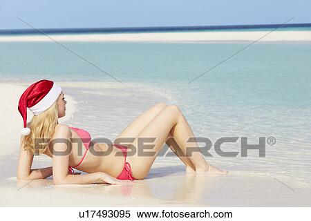 Woman Lying On Beach Wearing Santa Hat View Large Photo Image Stock Photography - Woman Lying On Beach Wearing Santa Hat. Fotosearch