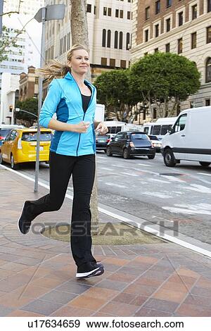 Woman Running Along Urban Street View Large Photo Image Stock Photo - Woman Running Along Urban Street. Fotosearch